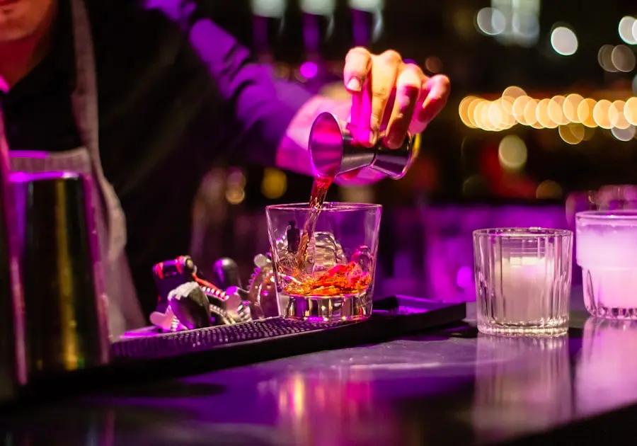 Bartender pouring into cocktail